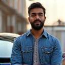 Zahir H. with car in background